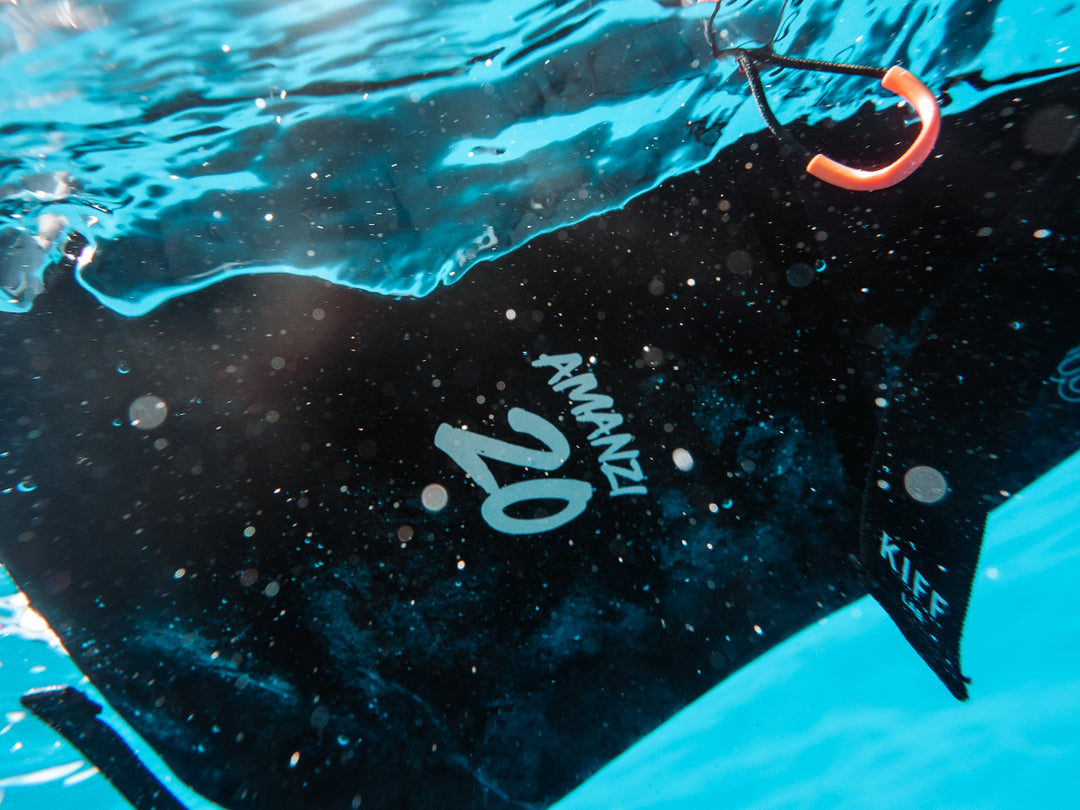 black waterproof backpack Amanzi floating on water